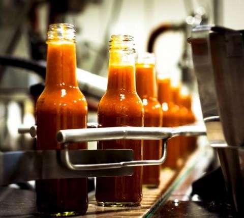 Bottles are filled along a production line at the factory of hot sauce company Culley's in Auckland, New Zealand in this 2014 handout photo obtained by Reuters April 24, 2015. REUTERS/Culley's/Handout via Reuters
