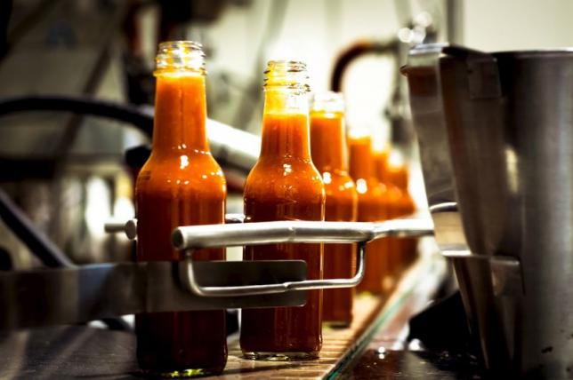 Bottles are filled along a production line at the factory of hot sauce company Culley's in Auckland, New Zealand in this 2014 handout photo obtained by Reuters April 24, 2015. REUTERS/Culley's/Handout via Reuters